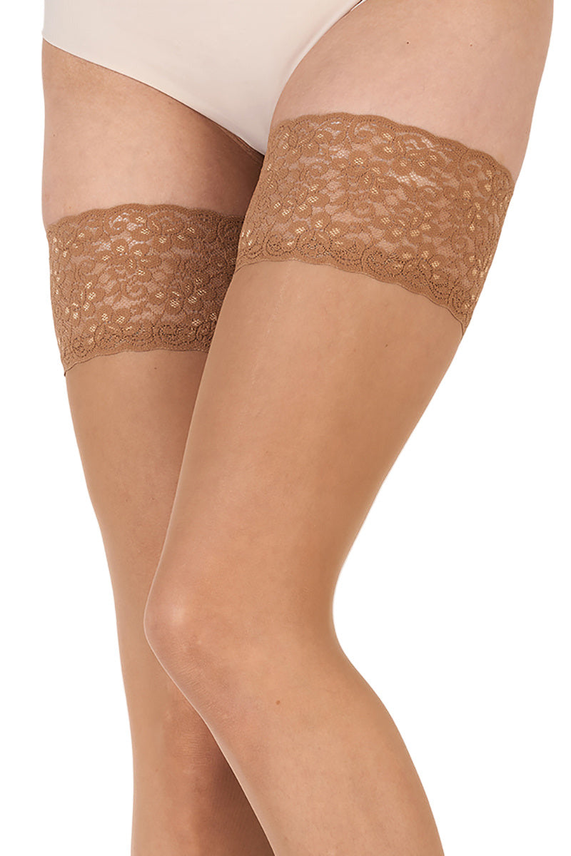Nude hold ups with lace top on a white background