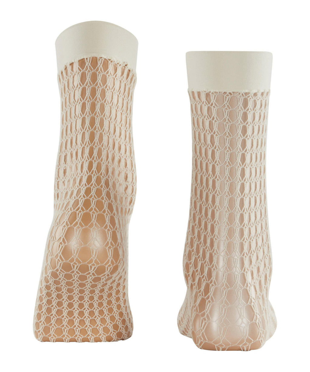 Pair of beige fishnet socks with white tops on a white background