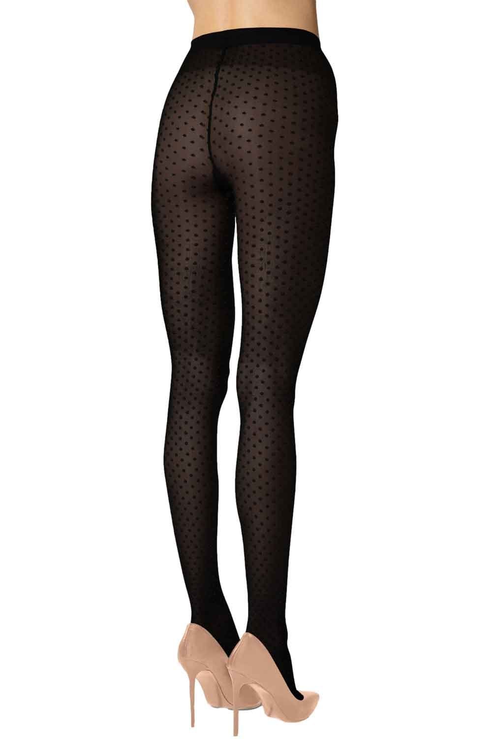 Black polka dot tights worn by a person on a white background