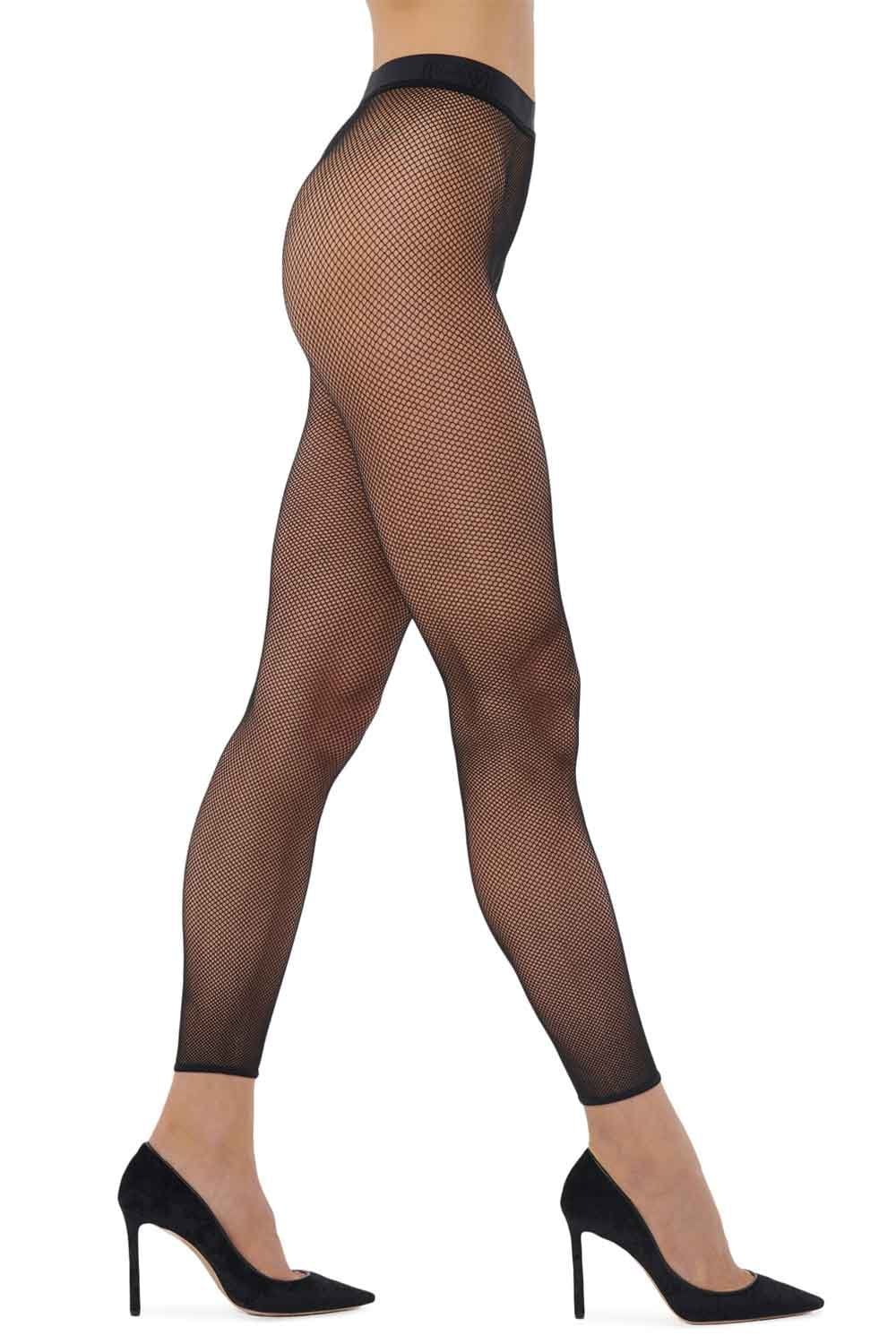 Black fishnet patterned leggings worn by a model on a white background