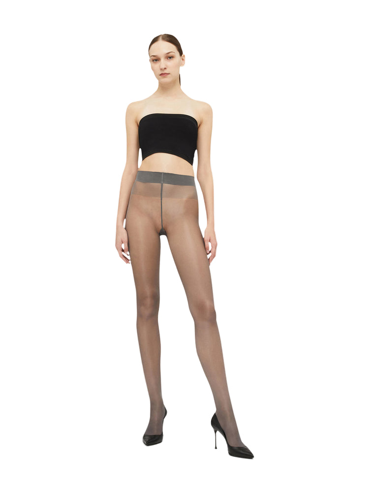 model wearing satin 20 tights and a black top on a white background