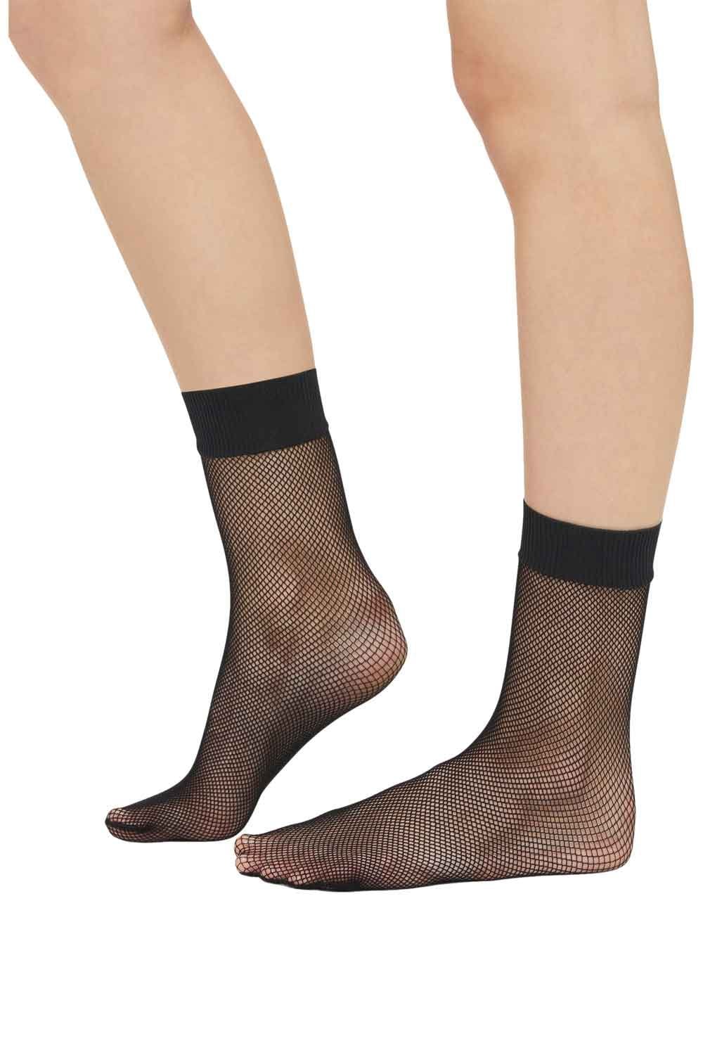 Black fishnet socks worn by a model on a white background