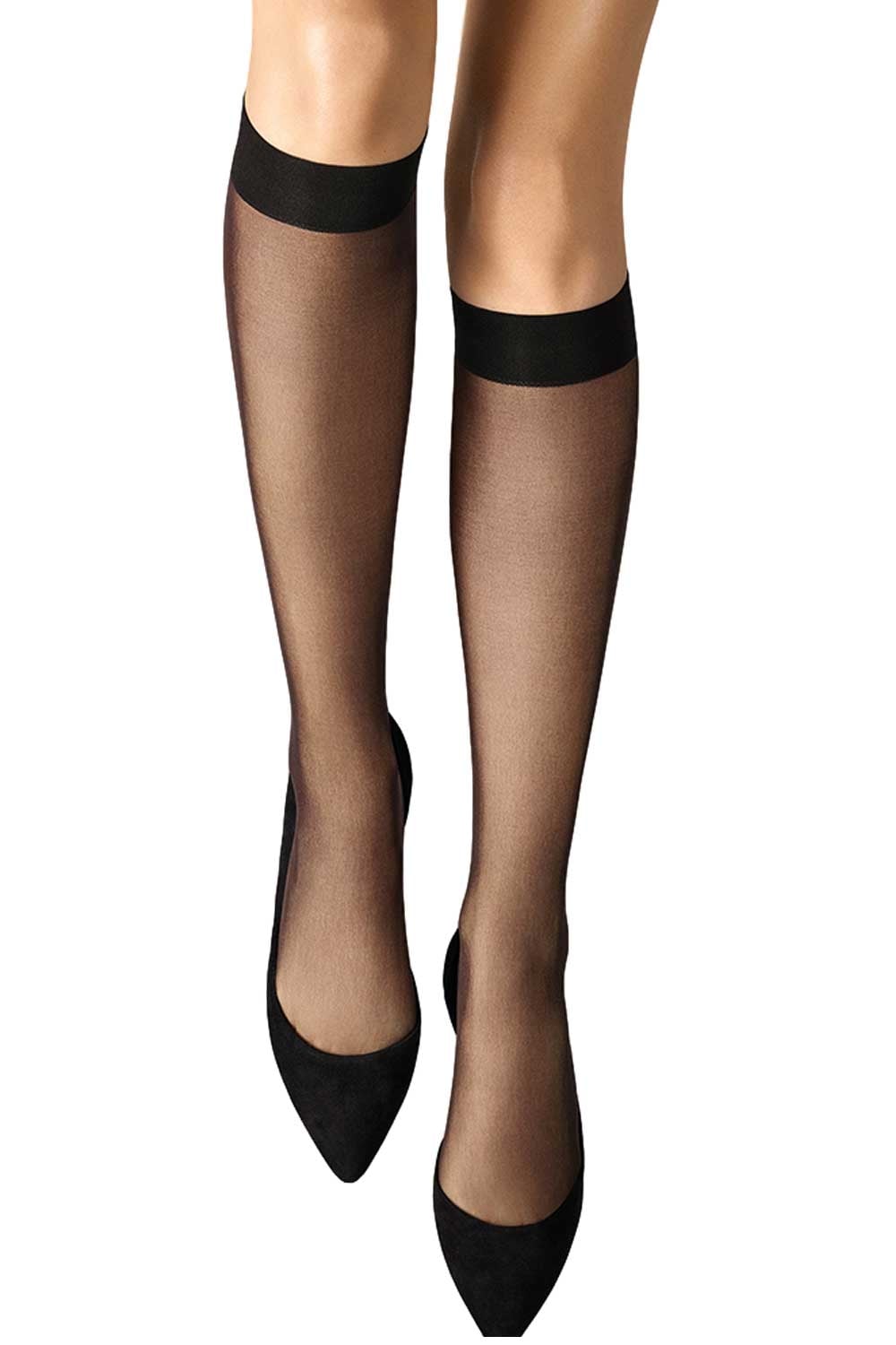 Wolford black knee highs  worn with black shoes on a white background