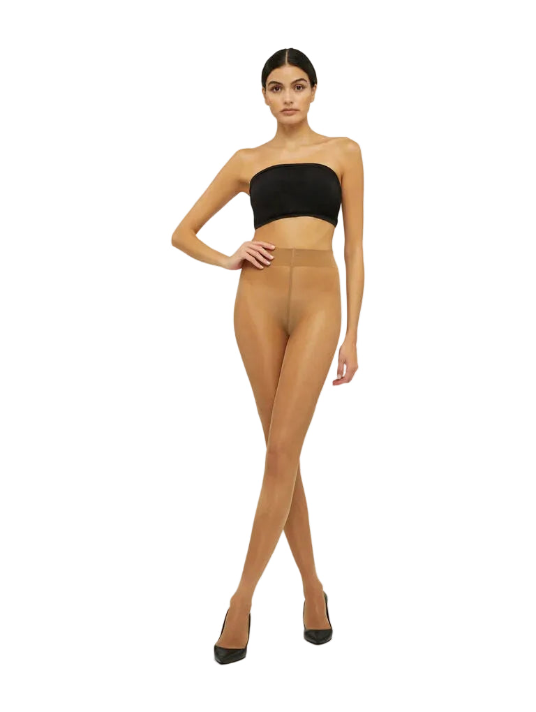 Model wearing sheer beige tights with a black bandeau top on a white background