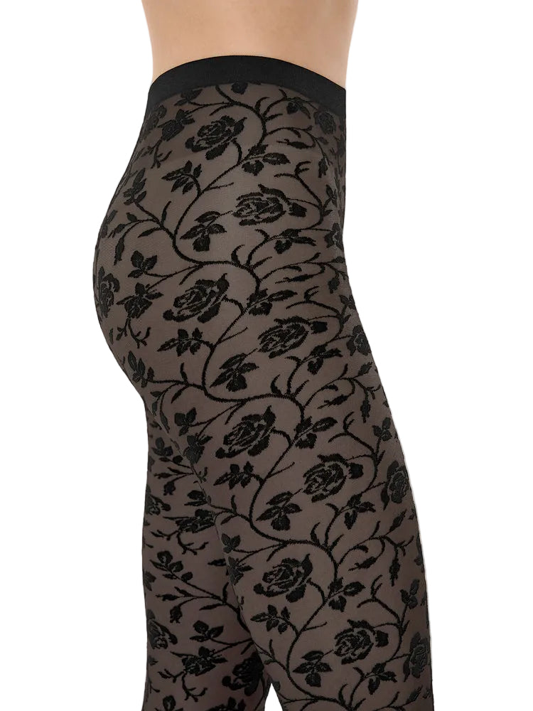 Black floral patterned tights on a beige background