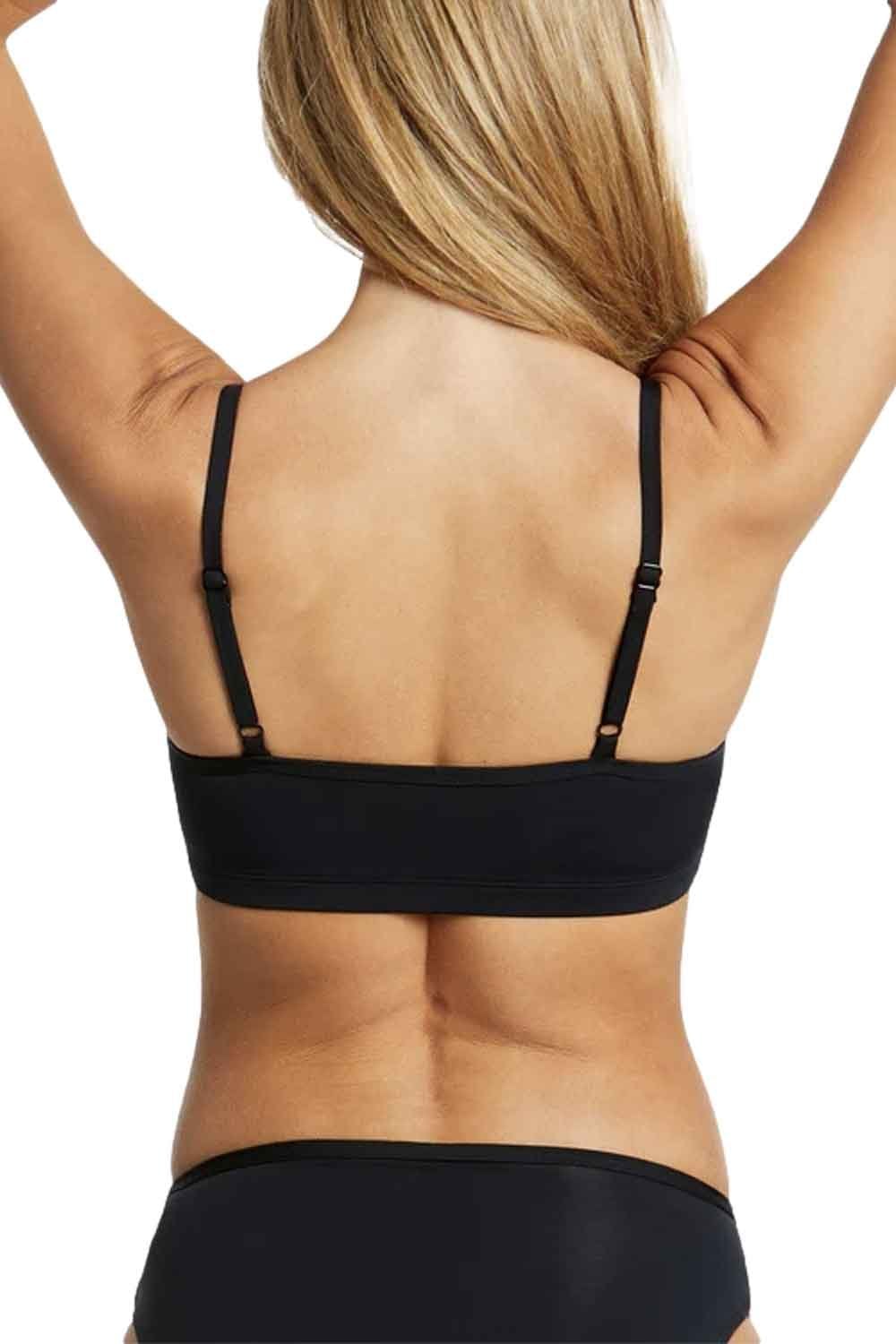 Black womens swim bikini top worn by a person with arms raised on a white background