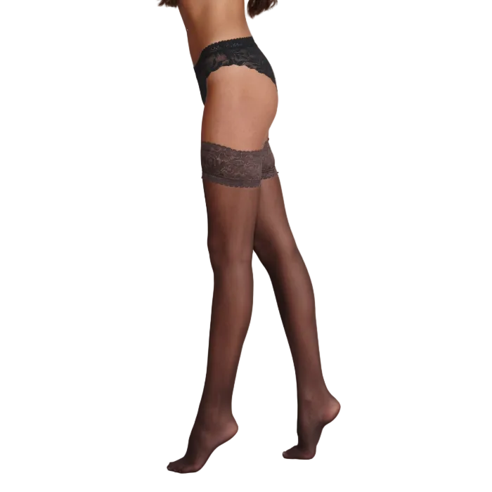 Barely black sheer hold ups with lace top worn by a model on a white background