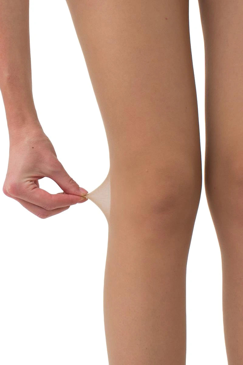 A close-up of a person's leg stretching the tights to demonstrate the elasticity of a sheer hosiery or skin-tightening material, with a hand pulling the fabric upward against a plain white background.