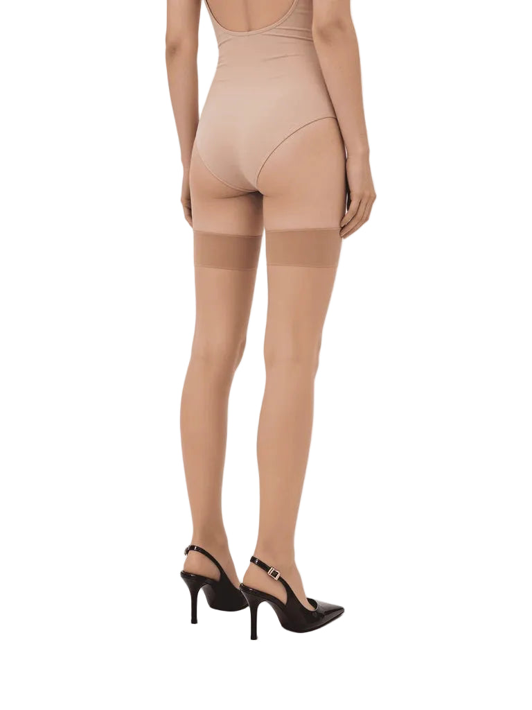 Beige shapewear and stockings being worn by a model on a white background
