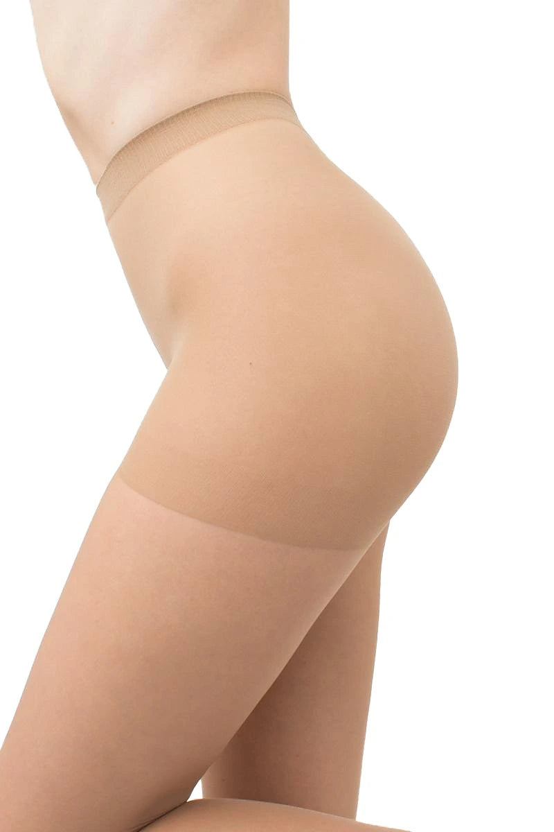 Close-up side view of a model's hip and upper leg wearing sheer nude hosiery against a plain white background.